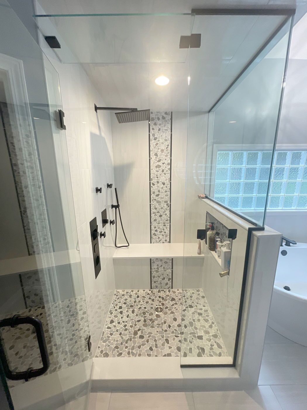 A tub nested in a window bay, completed by Footprints Bath and Tile Lawrenceville / Sugar Hill.