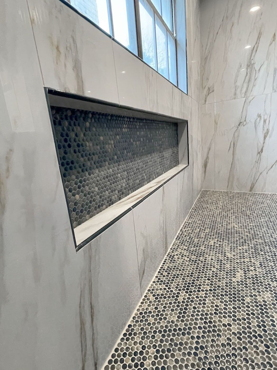 Newly installed gray tile in a shower by Footprints Bath and Tile Lawrenceville / Sugar Hill.