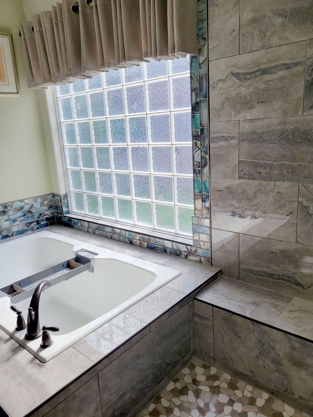 A clean, white tiled bathroom from Footprints Bath and Tile.